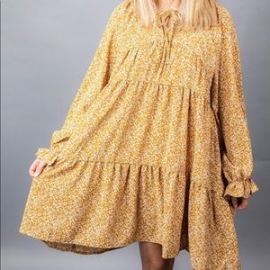 Mustard tiered ruffle dress with white floral print. NWT.